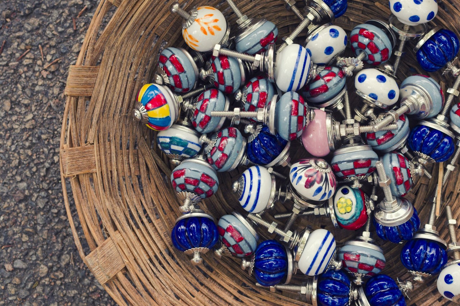 a basket filled with lots of colorful glass beads