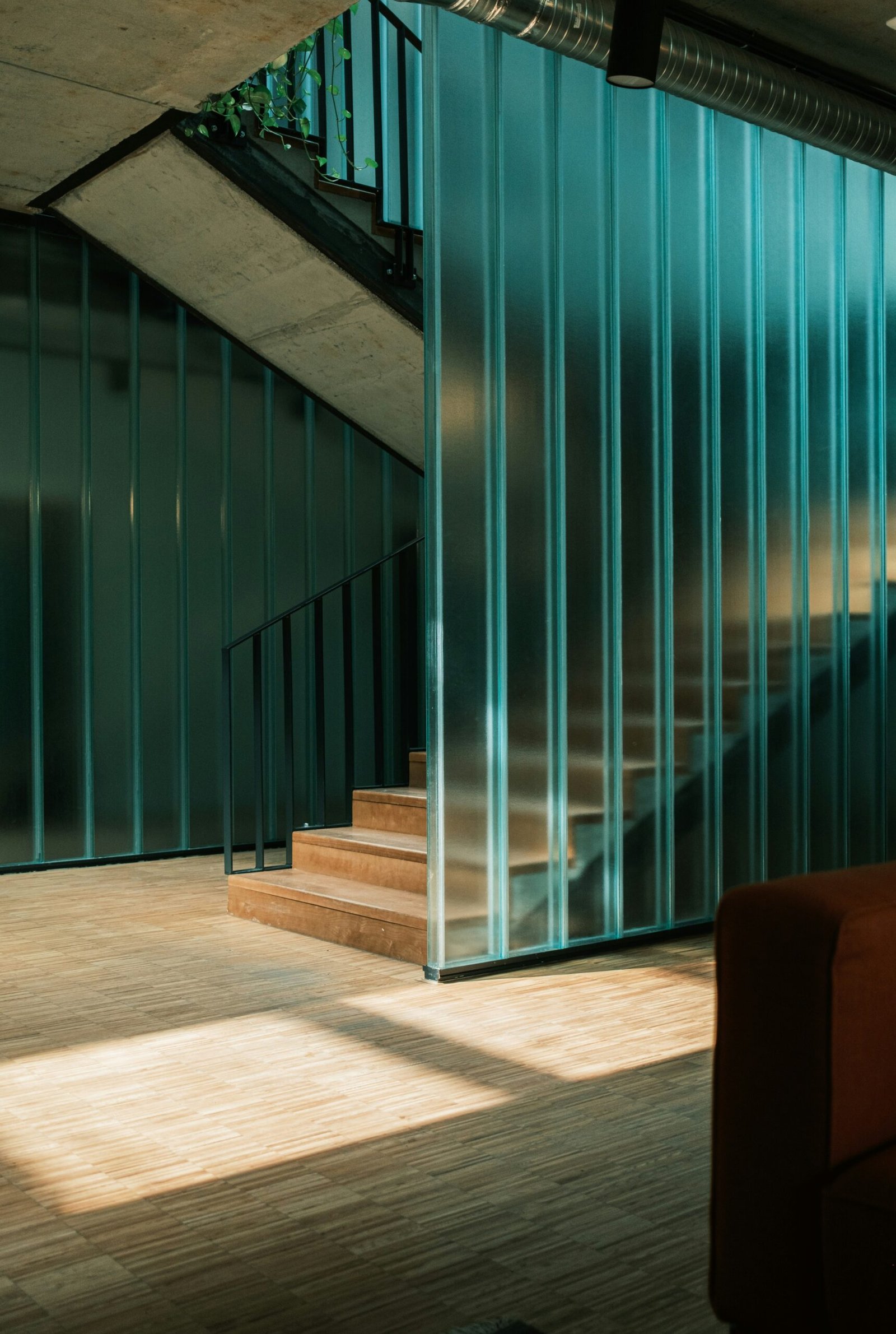 a living room with a couch and a stair case